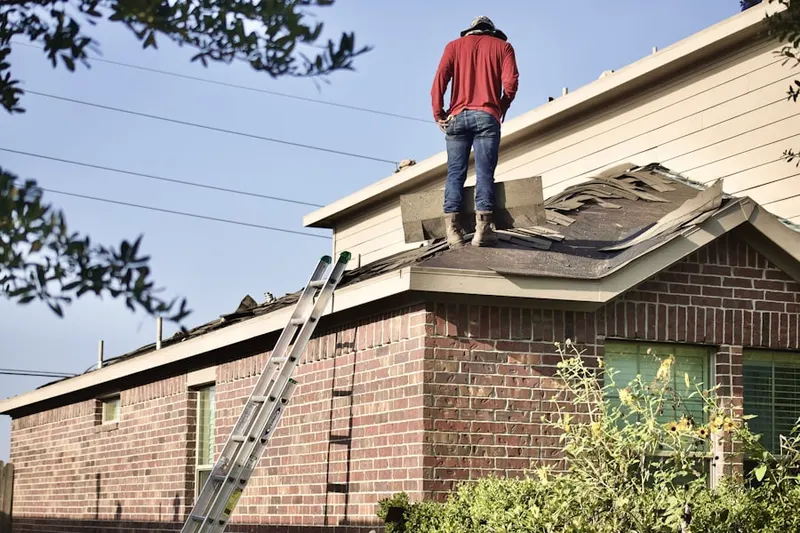 Professional roofer working on a residential roof in St. Simons